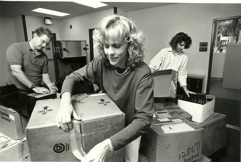 From left: Dennis Werner, senior research coordinator, Jan Marshburn, research assistant, and Lesley Bateman, PR and development coordinator, move into the new COPH building in November 1991.