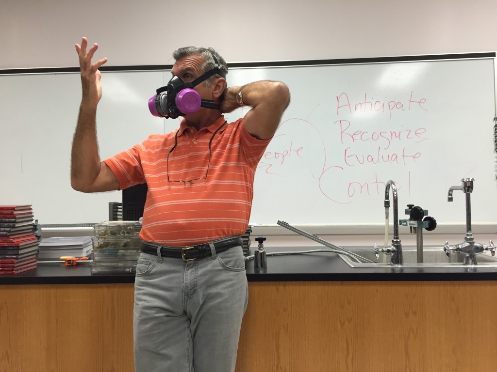 Salazar models some of the protective equipment that industrial hygienists wear when investigatiing environmental hazards.