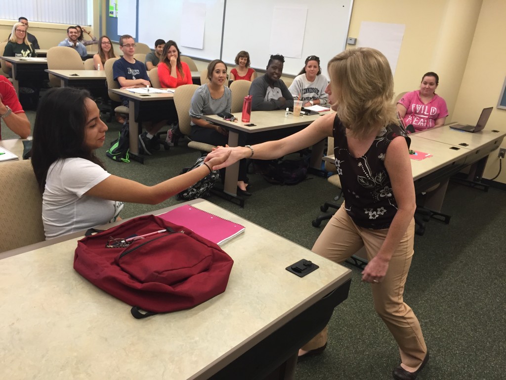 Kenia Aguilar and Laura Rusnak demonstrate the side side hand shake.