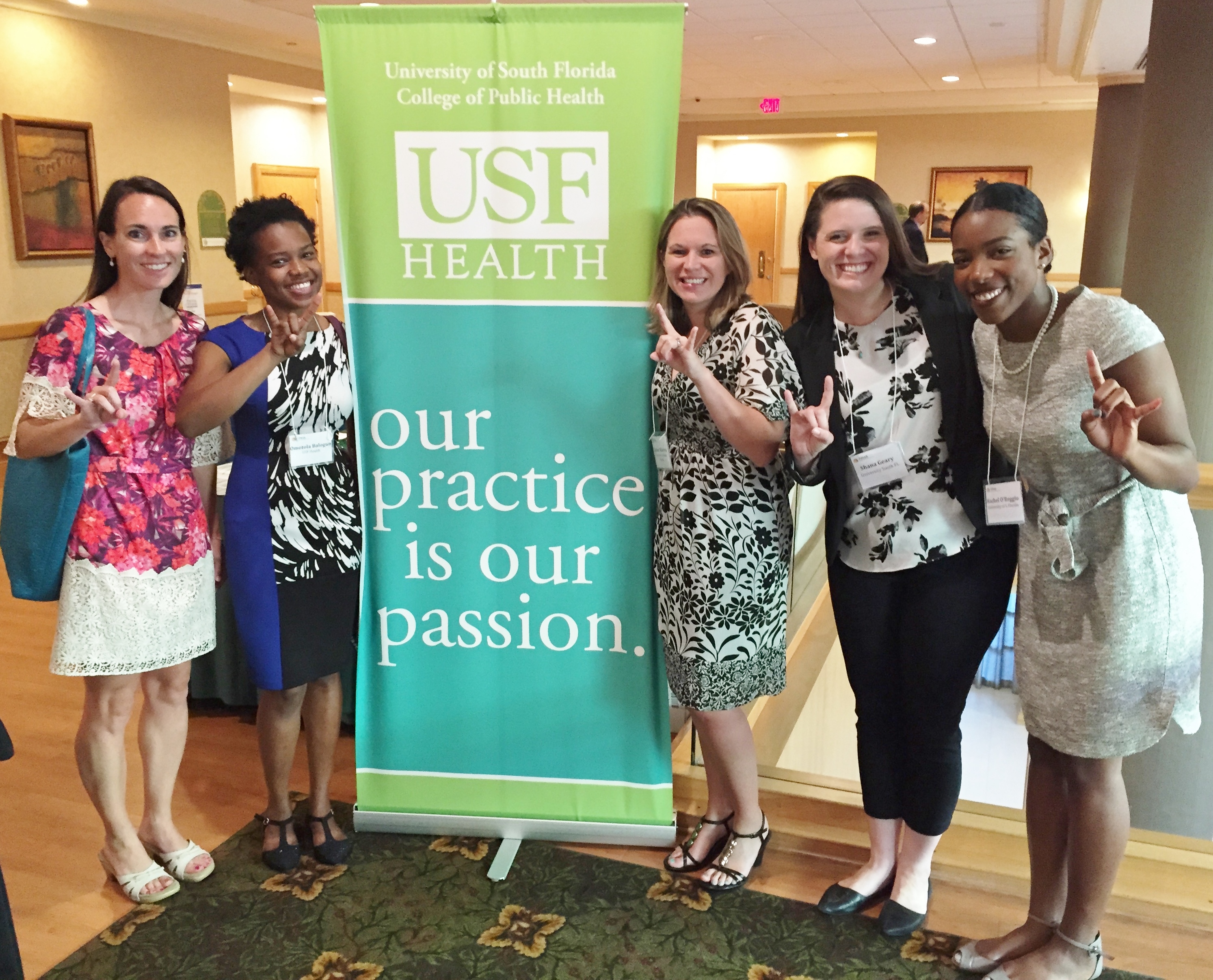 Student presenters and attendees strike a bullish pose during a conference break.