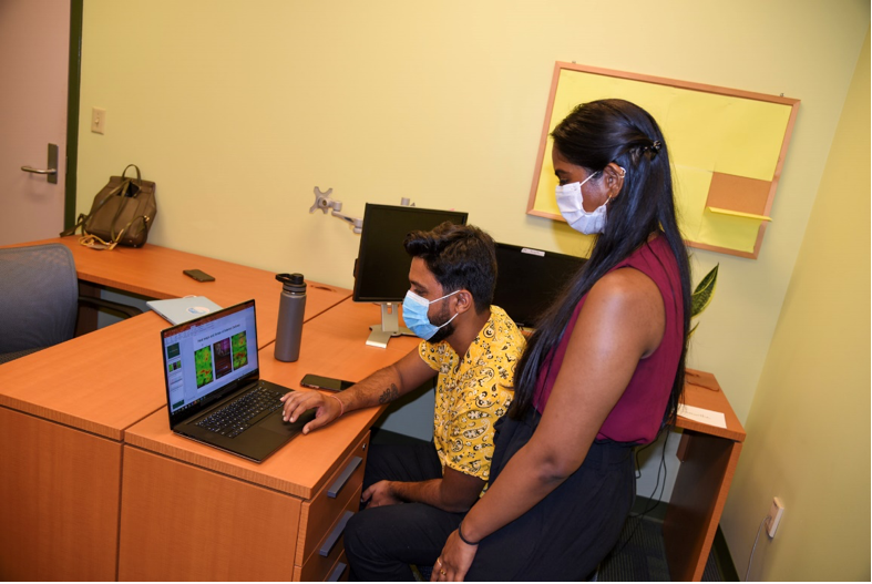 FPRC team members Samantha Boddupalli, behavioral research manager, and Vijay Prajapati, neuromarketing research manager, looking at results from their latest communications pretesting report for the Hispanic/Latinx general audience. (Photo by Caitlin Keough)