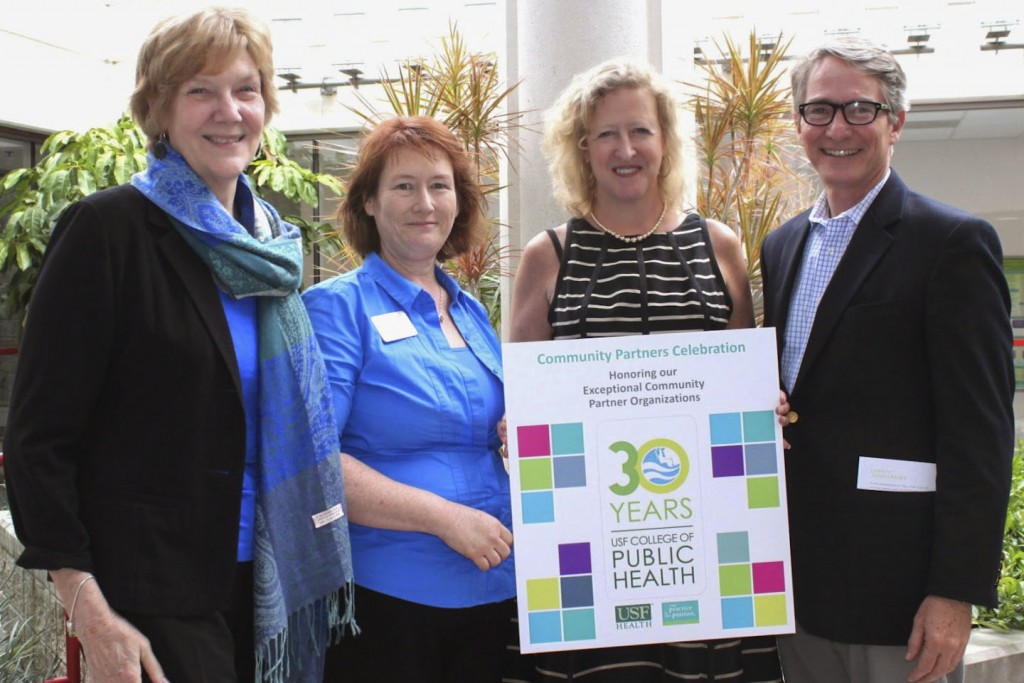 Dean Donna Petersen with Marti Coulter, professor and chair of the COPH community engagement committee, with community partners from Champions for Children, Brian McEwen and Amy Haile. “Our community partners are the foundation of our research, teaching, and practice. Without their collaboration and help we would not be a College of Public Health” said Coulter. Photo by Ellen Kent